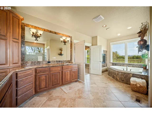 a large bathroom with a large tub and sink