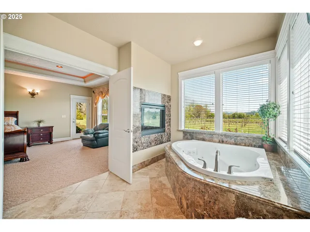 a view of living room filled with furniture and large windows
