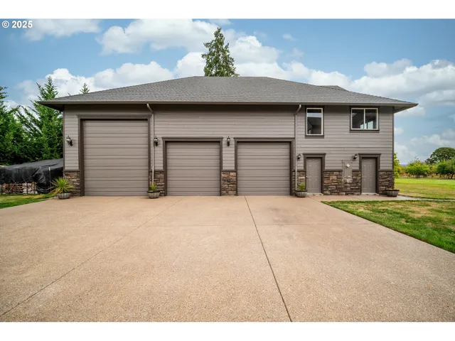 a front view of a house with a yard and garage
