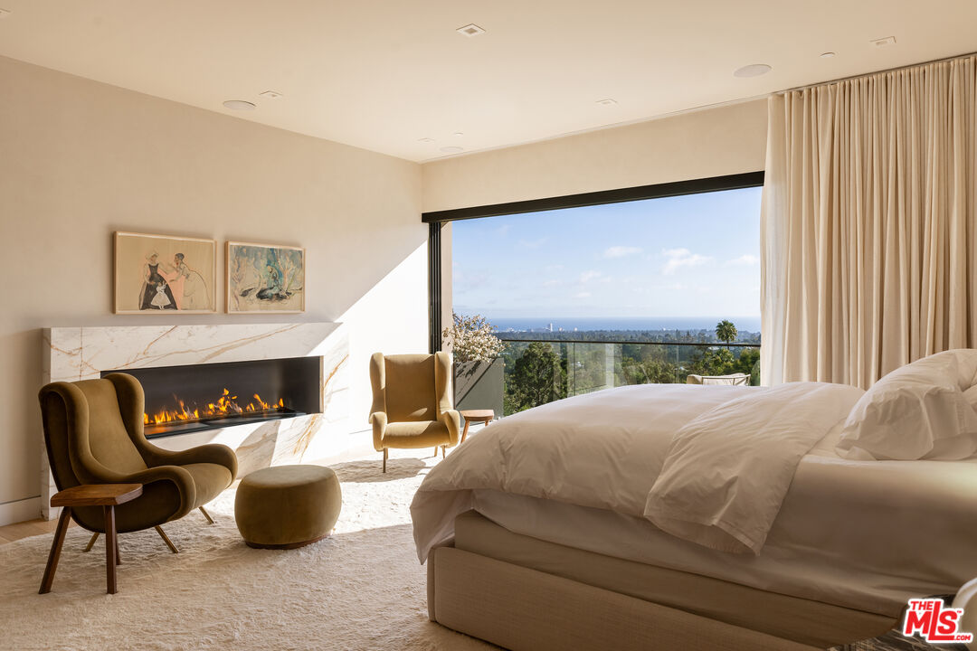 815 North Tigertail Road Los Angeles, CA 90049 - Photo 13 of 26 a bedroom with a bed and a large window