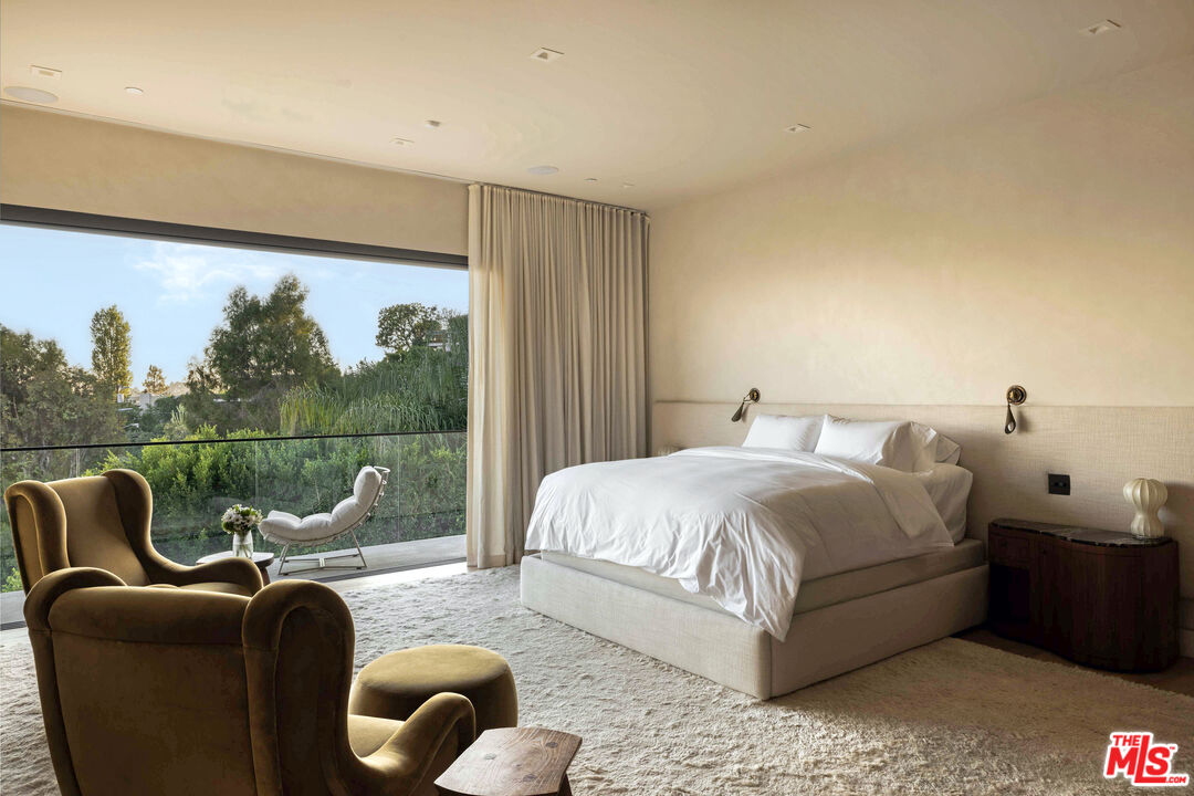 815 North Tigertail Road Los Angeles, CA 90049 - Photo 15 of 26 a bedroom with bed couch and window