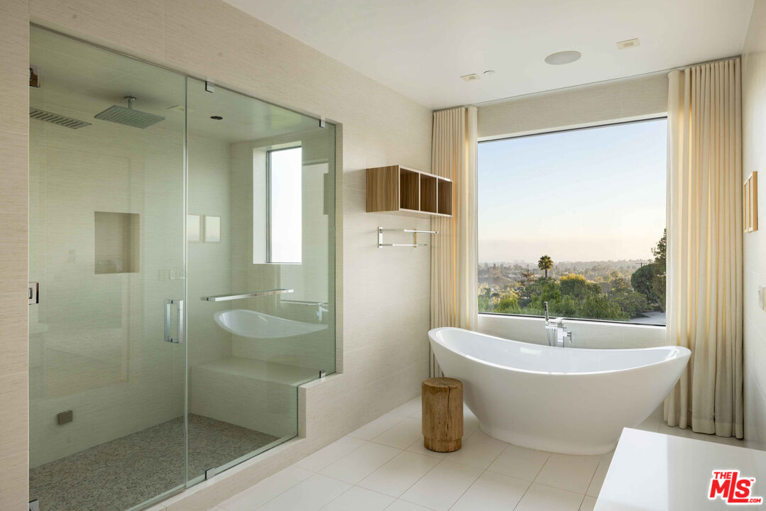 815 North Tigertail Road Los Angeles, CA 90049 - Photo 16 of 26 a view of a bathroom with a tub shower and sink