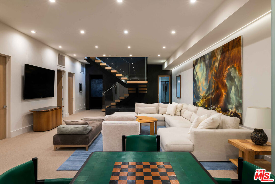 815 North Tigertail Road Los Angeles, CA 90049 - Photo 20 of 26 a living room with furniture and a flat screen tv