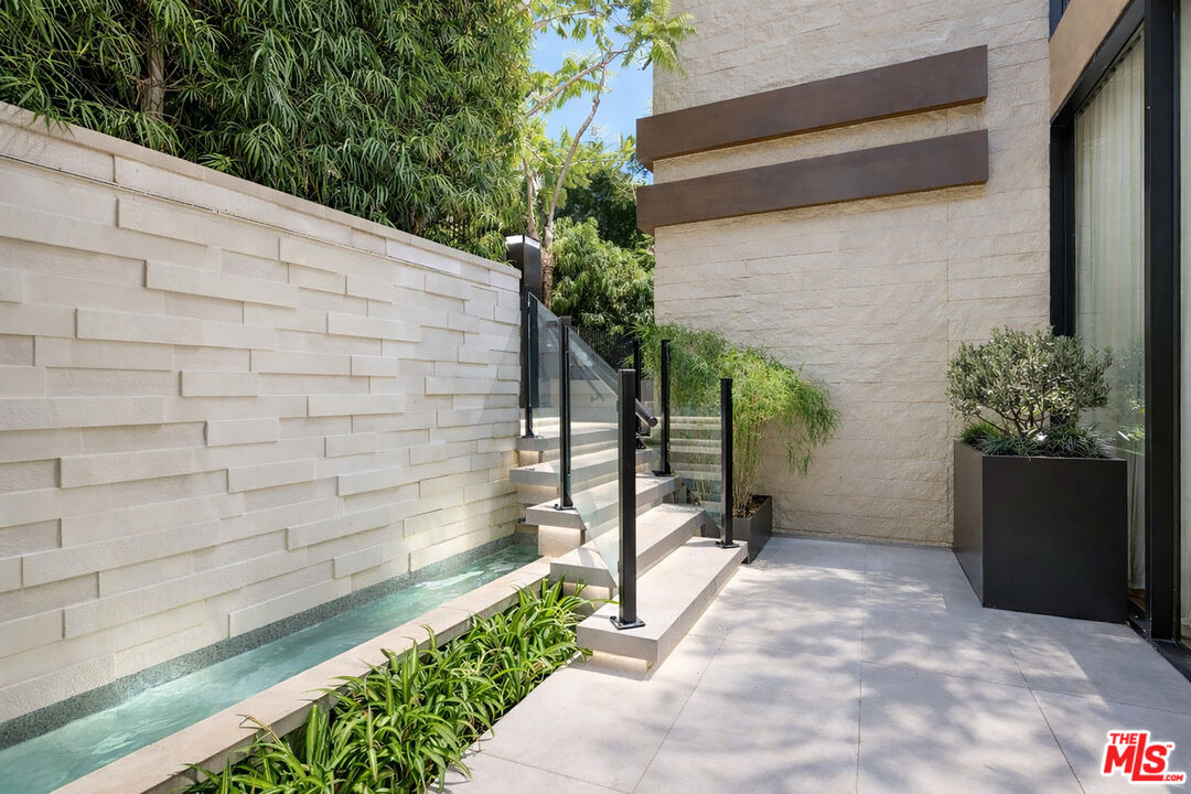 815 North Tigertail Road Los Angeles, CA 90049 - Photo 2 of 26 a backyard of a house with plants and trees