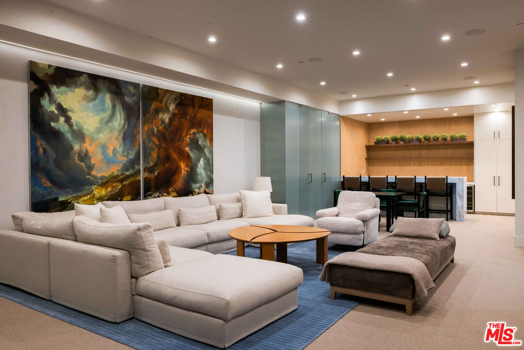 815 North Tigertail Road Los Angeles, CA 90049 - Photo 21 of 26 a living room with furniture and a flat screen tv