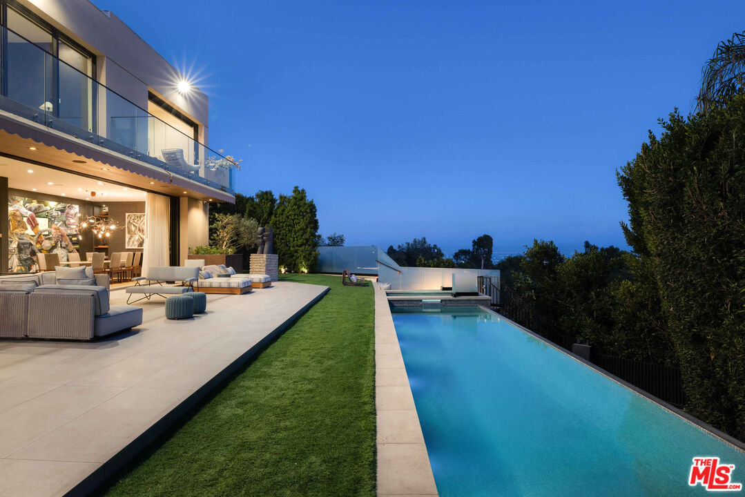 815 North Tigertail Road Los Angeles, CA 90049 - Photo 26 of 26 a view of a swimming pool with an outdoor seating and a garden