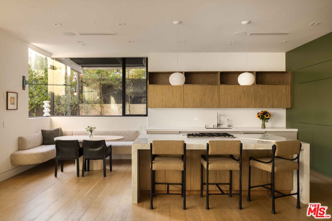 815 North Tigertail Road Los Angeles, CA 90049 - Photo 9 of 26 a view of a dining room with furniture and wooden floor