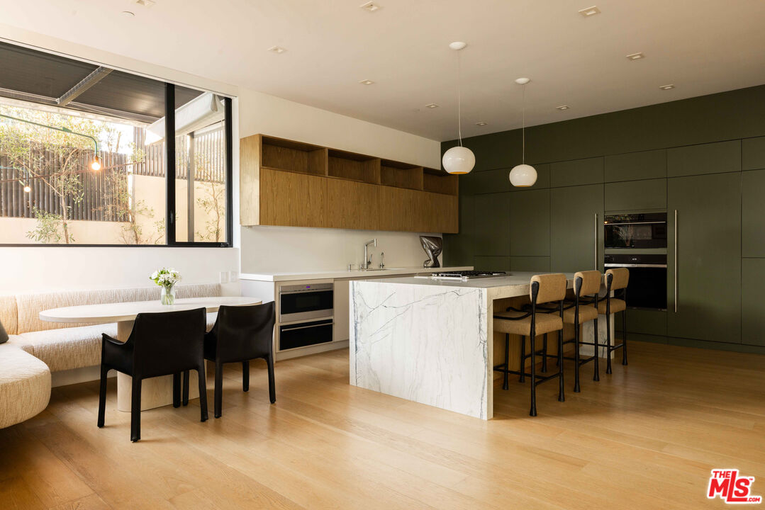 815 North Tigertail Road Los Angeles, CA 90049 - Photo 10 of 26 a kitchen with a table and chairs in it