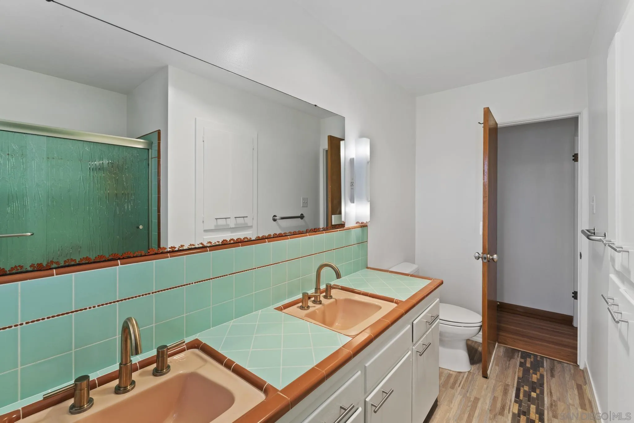 923 Sunset Drive Vista, CA 92081 - Photo 14 of 74 a bathroom with a sink and a mirror