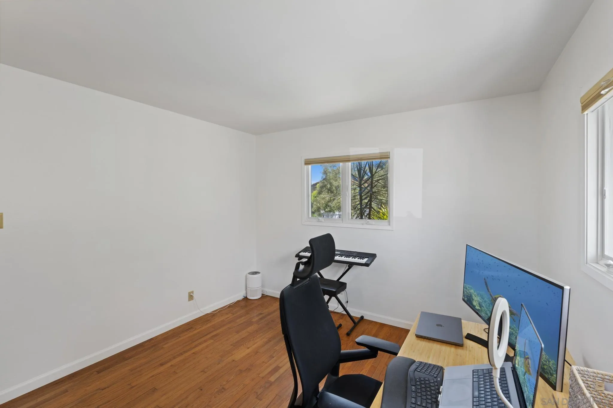 923 Sunset Drive Vista, CA 92081 - Photo 21 of 74 a view of a workspace with furniture and wooden floor
