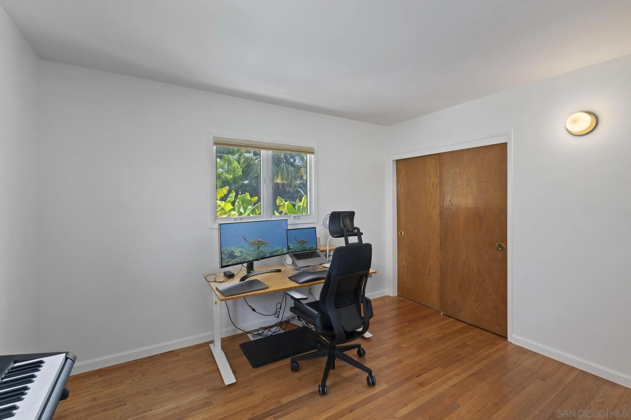923 Sunset Drive Vista, CA 92081 - Photo 23 of 74 a workspace with furniture and wooden floor