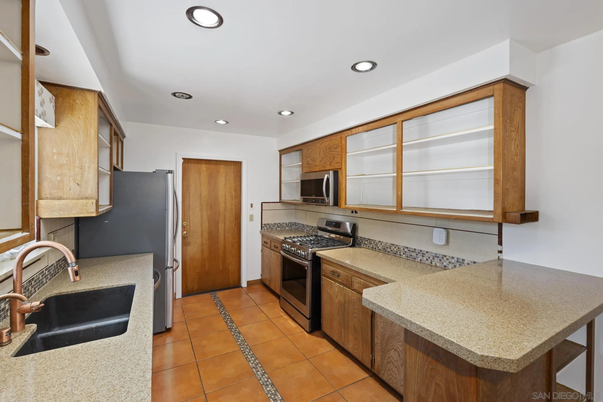 923 Sunset Drive Vista, CA 92081 - Photo 3 of 74 a kitchen with stainless steel appliances granite countertop a sink stove and refrigerator