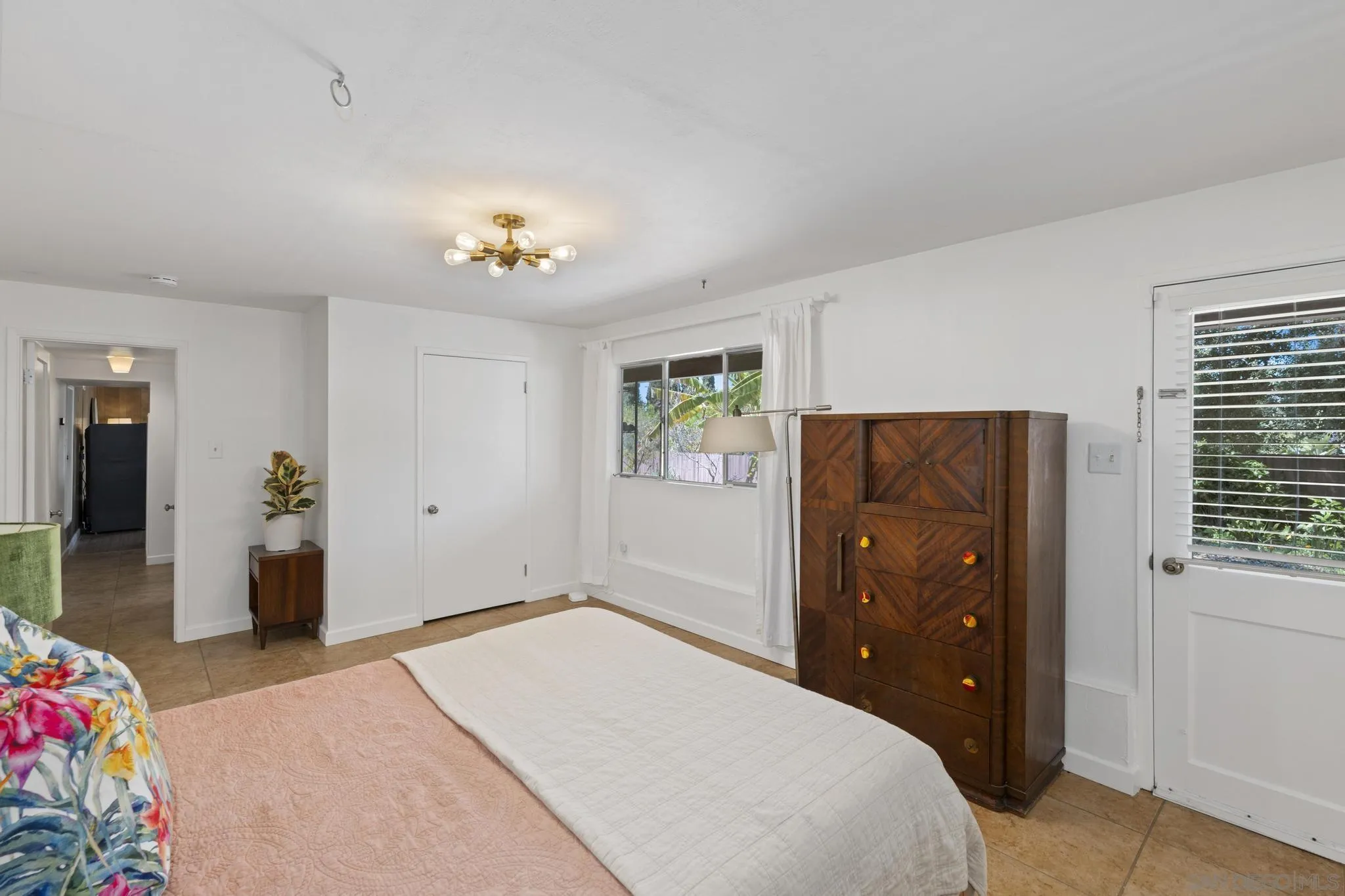 923 Sunset Drive Vista, CA 92081 - Photo 31 of 74 a bedroom with a bed and a dresser