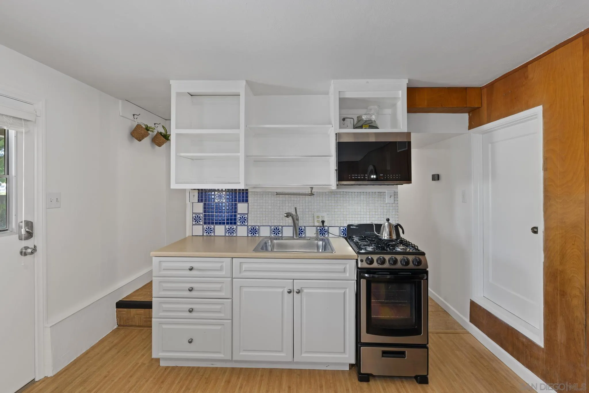 923 Sunset Drive Vista, CA 92081 - Photo 36 of 74 a kitchen with a stove and a microwave