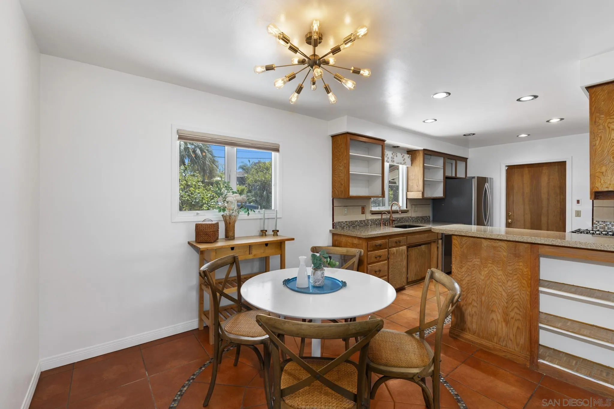 923 Sunset Drive Vista, CA 92081 - Photo 9 of 74 a view of a dining room with furniture and a chandelier