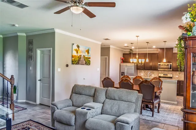 a living room with furniture and a chandelier