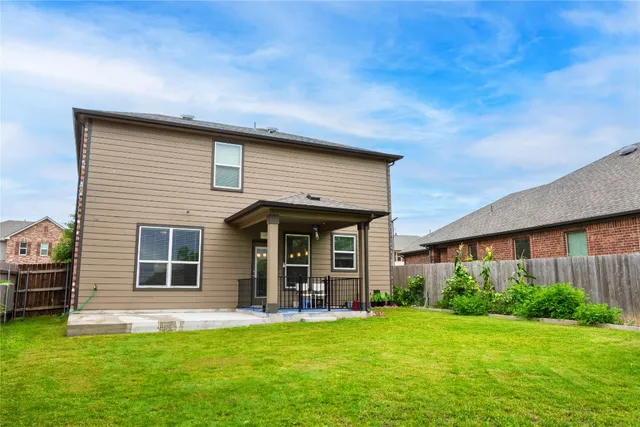 a view of a chair and table in the garden
