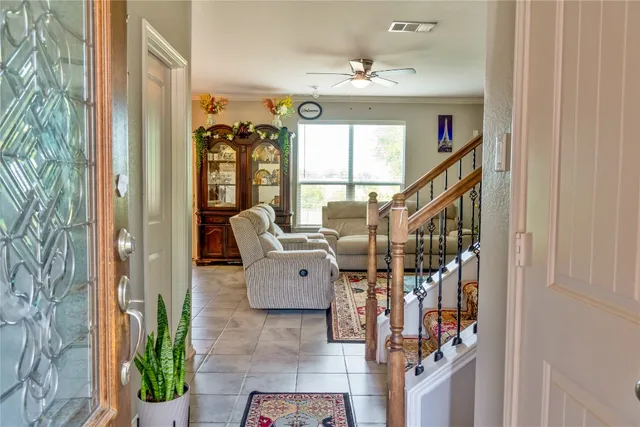 a living room with furniture and a potted plant