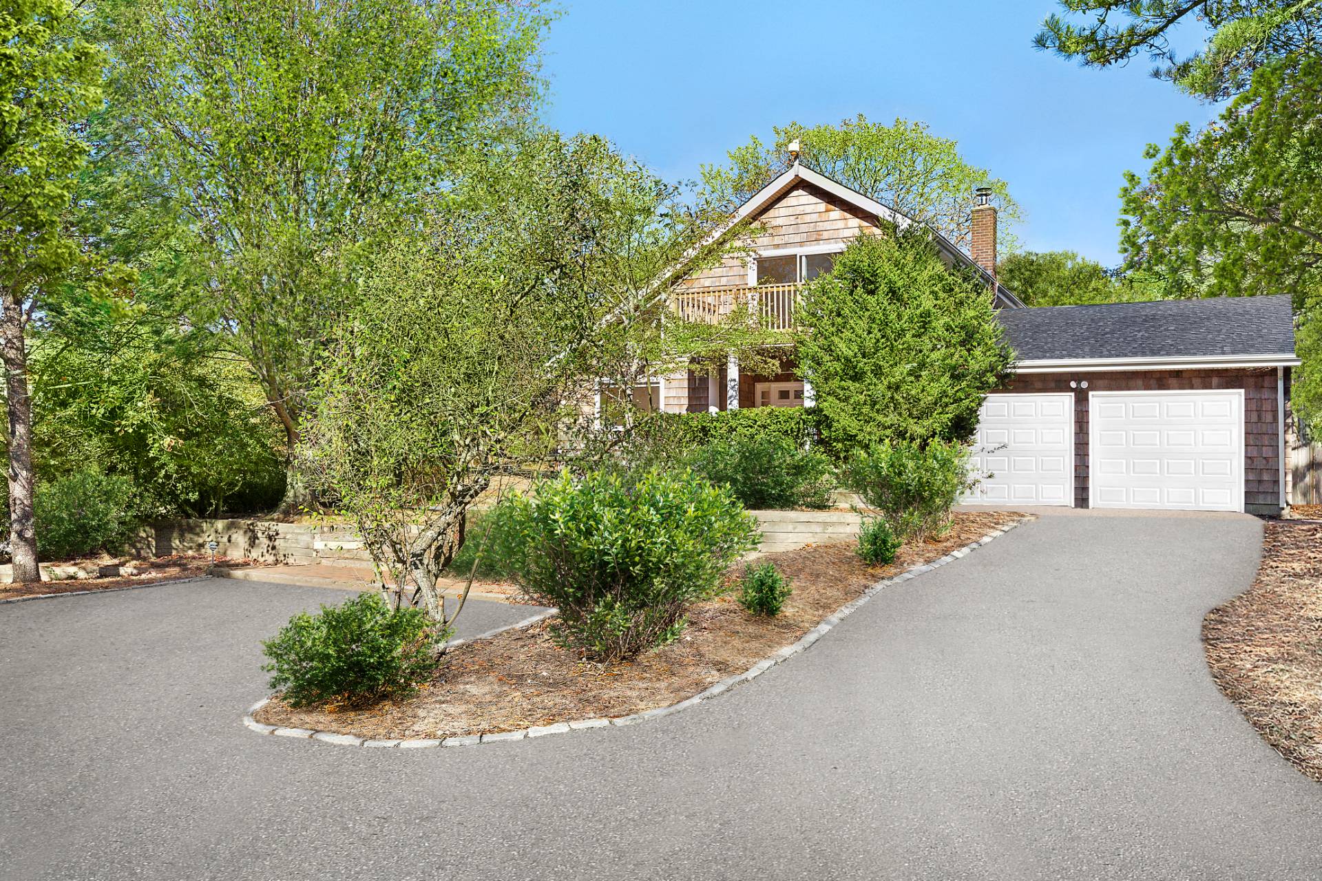 16 Peconic Road Hampton Bays, NY 11946 - Photo 17 of 17 a front view of a house with a yard and garage