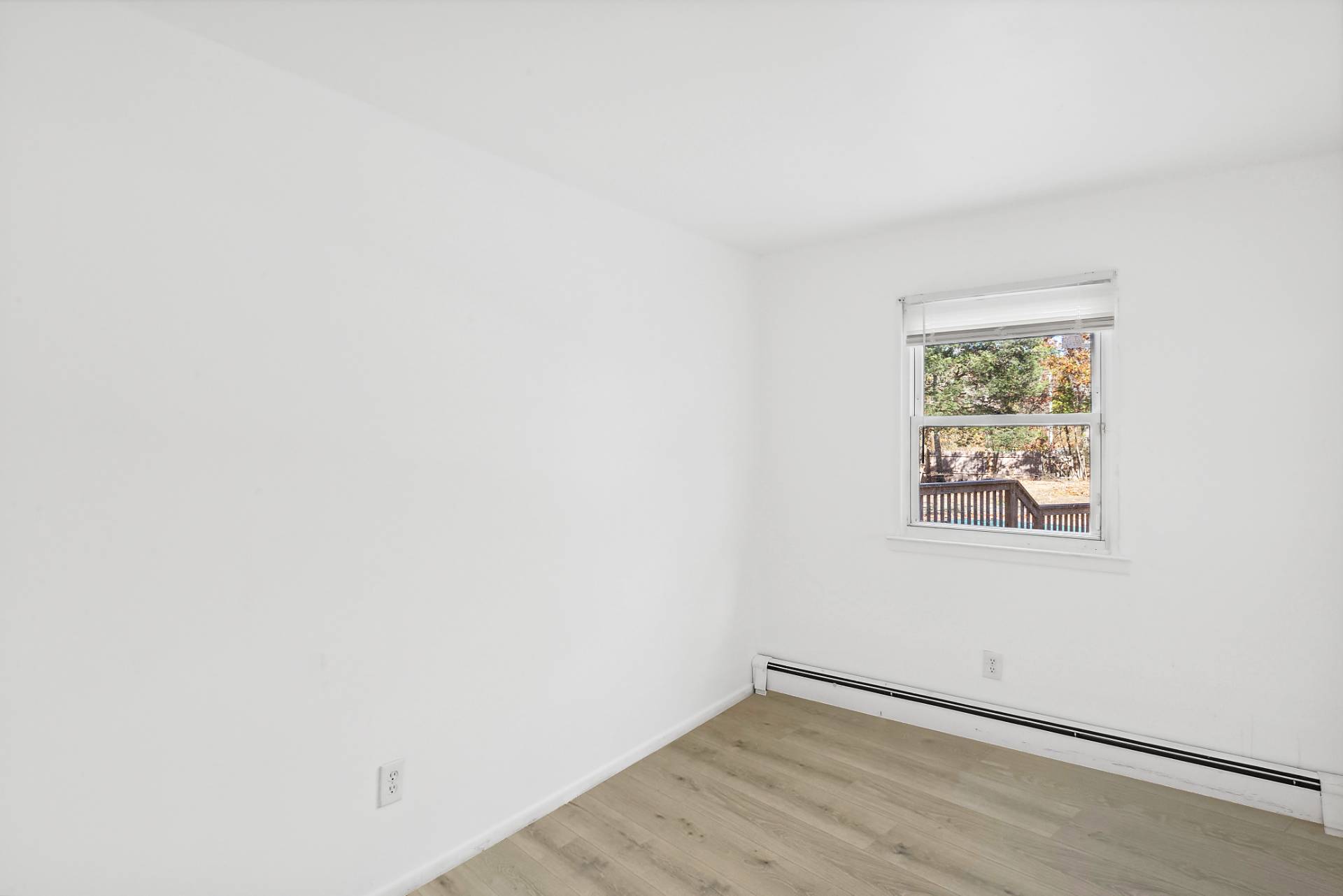 16 Peconic Road Hampton Bays, NY 11946 - Photo 9 of 17 an empty room with a window