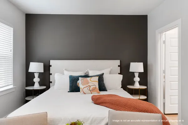 a bedroom with furniture and wooden floor