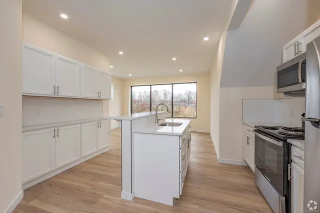 a kitchen with a stove a sink and a refrigerator