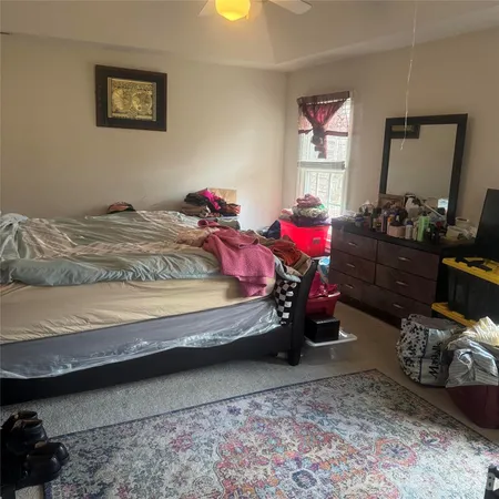 a bedroom with bed and a window