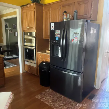 a kitchen with stainless steel appliances granite countertop a refrigerator and a sink