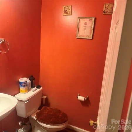 a white toilet sitting next to a bathroom sink