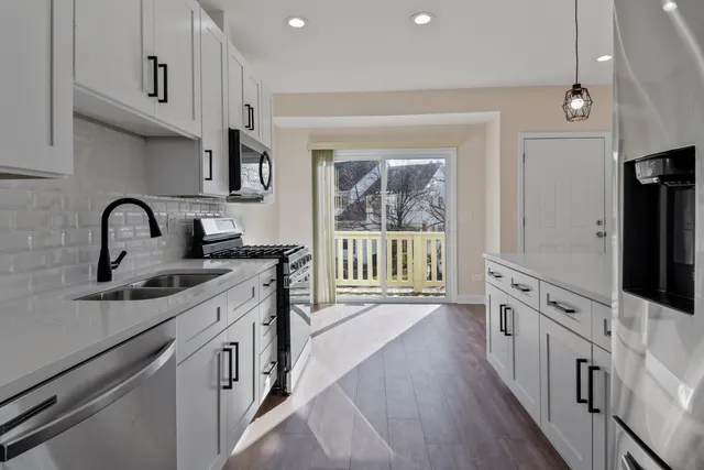 a kitchen with stainless steel appliances a sink and a stove top oven