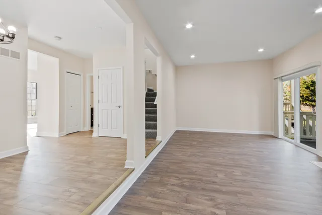 an empty room with wooden floor and fireplace