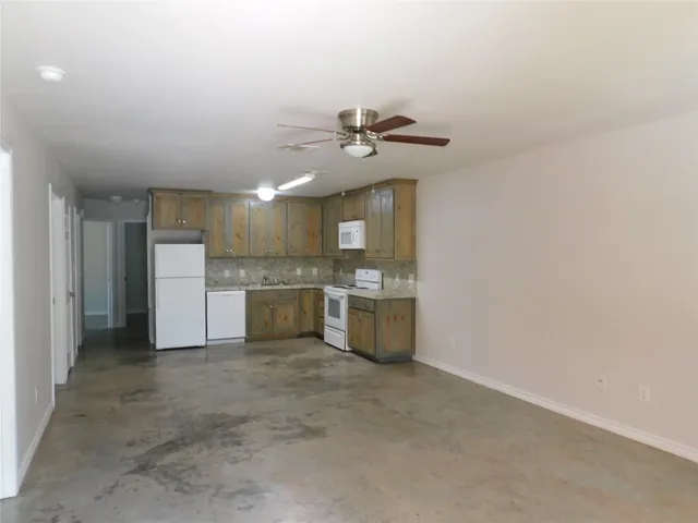 a view of a kitchen with a sink and a refrigerator