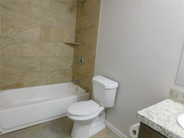a bathroom with a toilet a sink and bathtub
