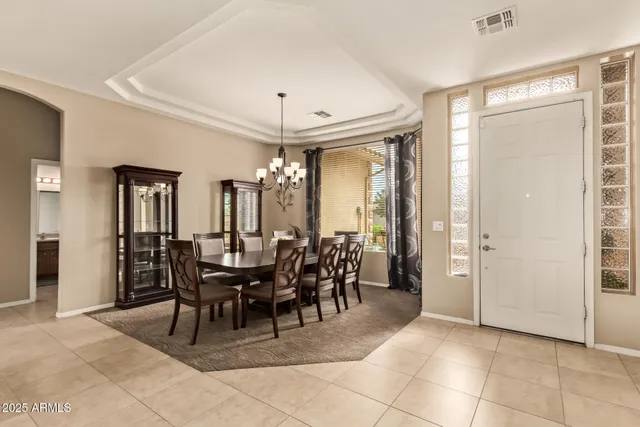 a view of a dining room with furniture and chandelier