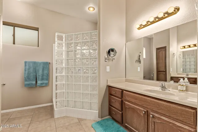 a bathroom with a double vanity sink a mirror and shower