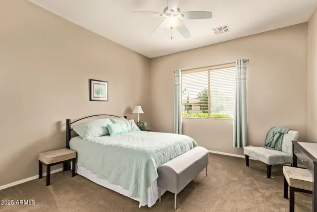 a bedroom with a bed and a couch