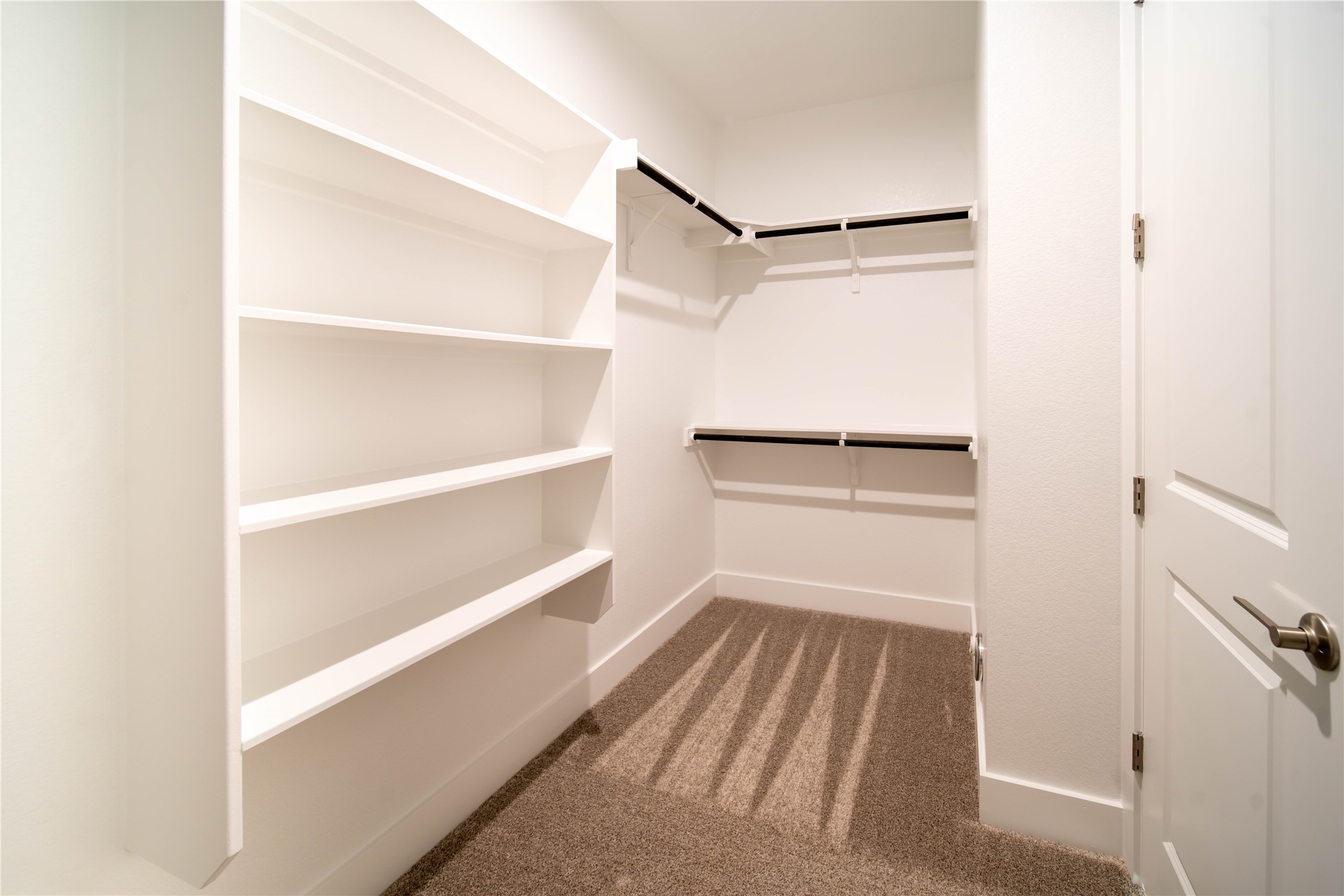 2029 Varese Path Leander, TX 78641 - Photo 16 of 32 a view of walk in closet with empty racks