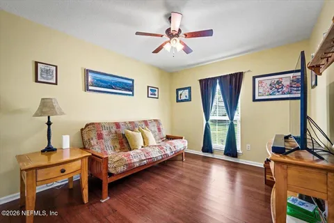 a bedroom with furniture and a flat screen tv