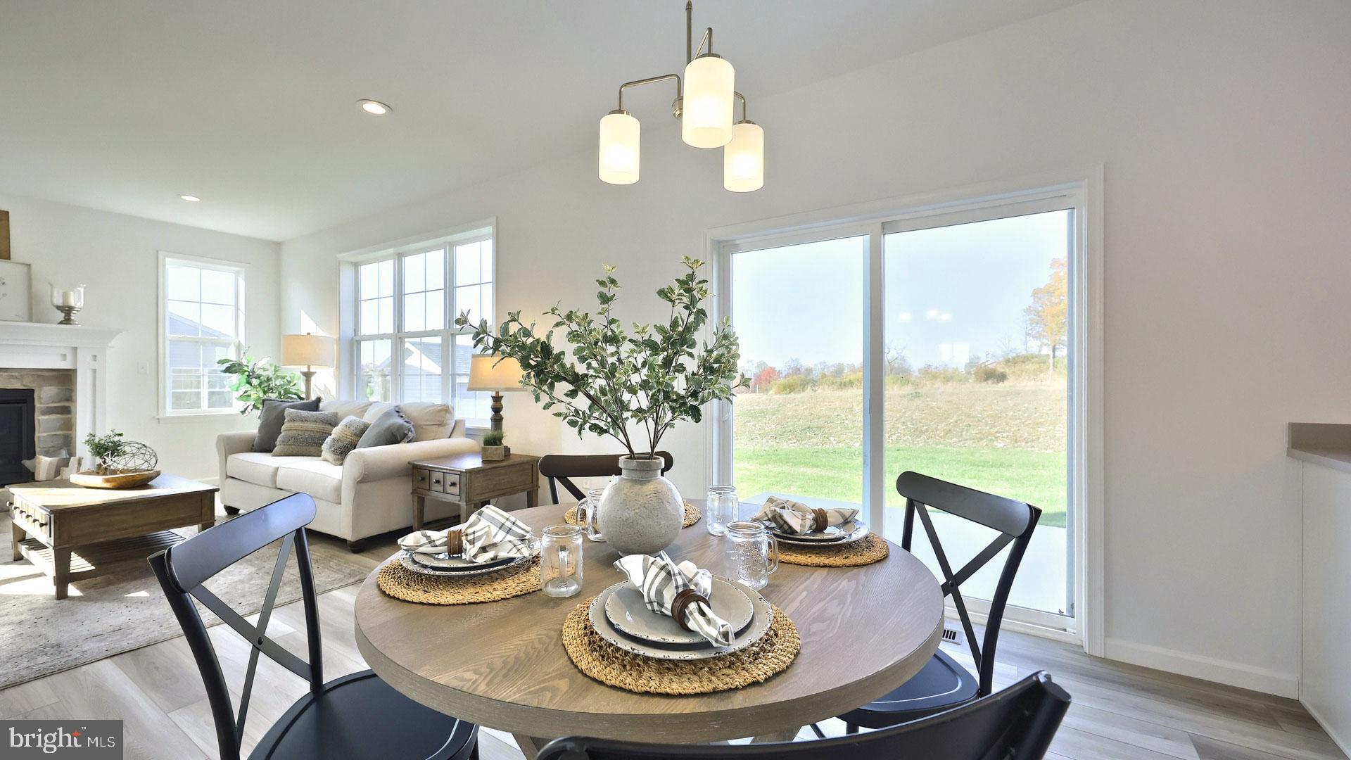 157 Copper Ridge Drive Newmanstown, PA 17073 - Photo 12 of 33 a dining room with furniture a large window and wooden floor