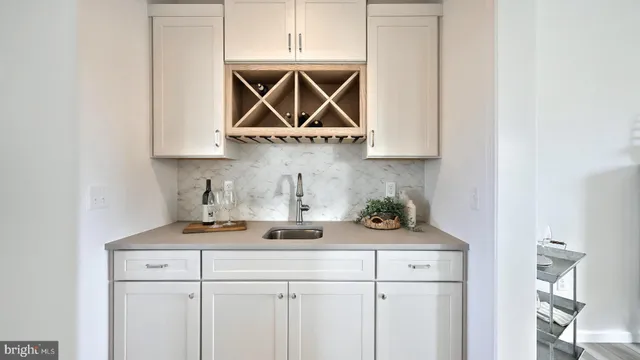 a kitchen with a stove a sink and cabinets