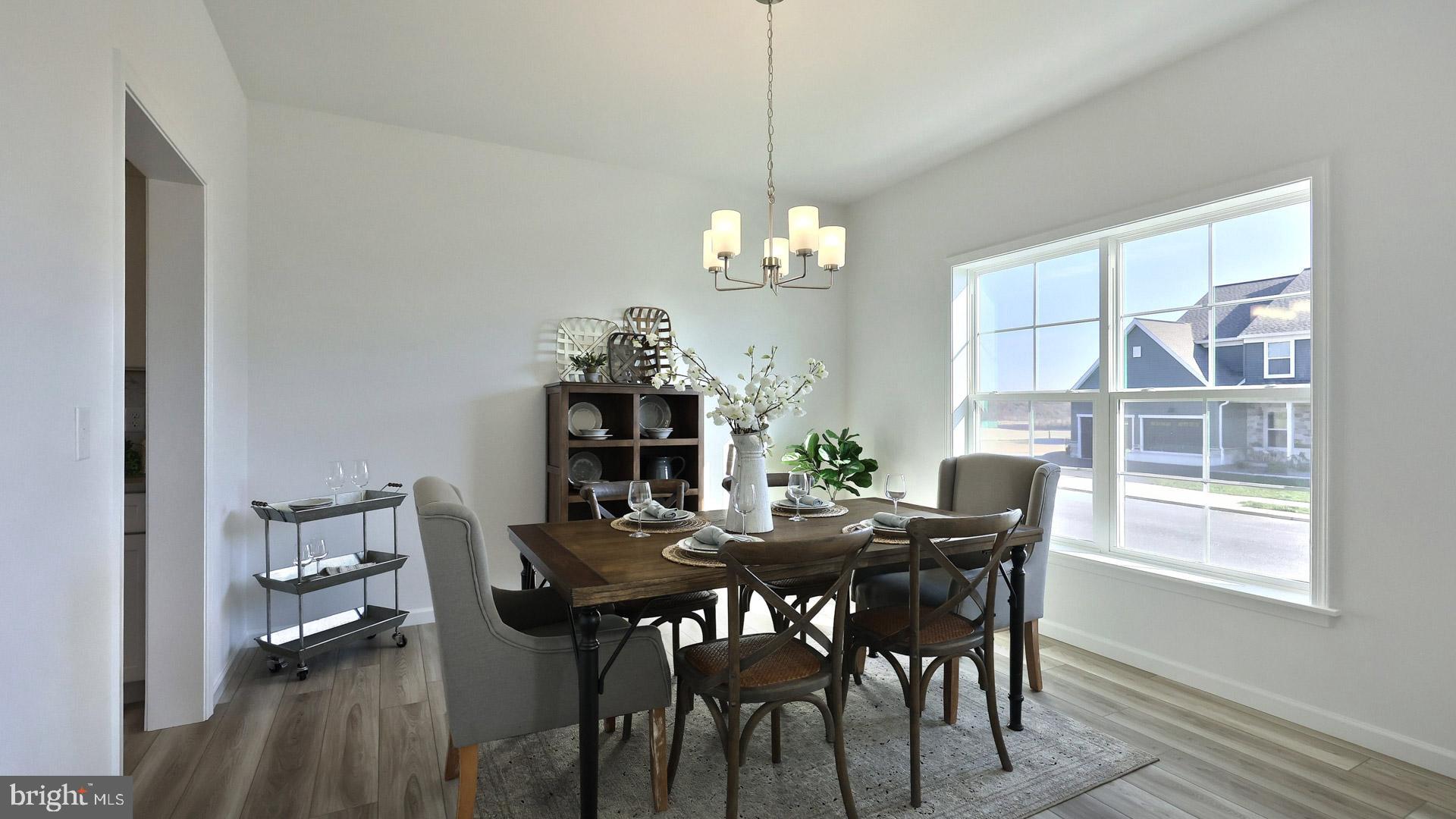 157 Copper Ridge Drive Newmanstown, PA 17073 - Photo 18 of 33 a view of a dining room with furniture a chandelier and wooden floor