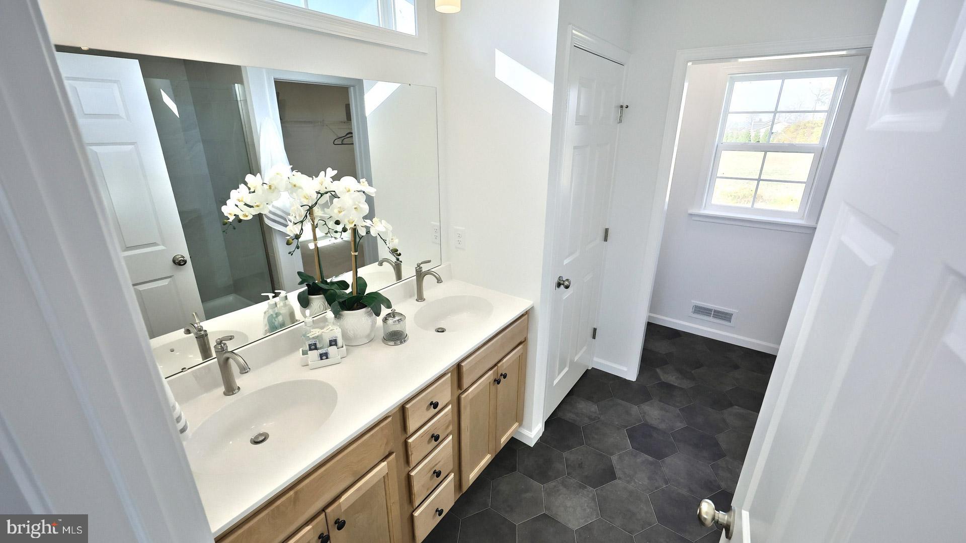 157 Copper Ridge Drive Newmanstown, PA 17073 - Photo 28 of 33 a spacious bathroom with a double vanity sink and a mirror