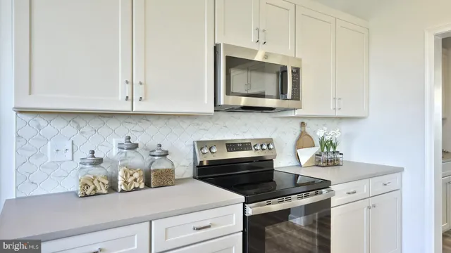 a kitchen with appliances cabinets and a microwave
