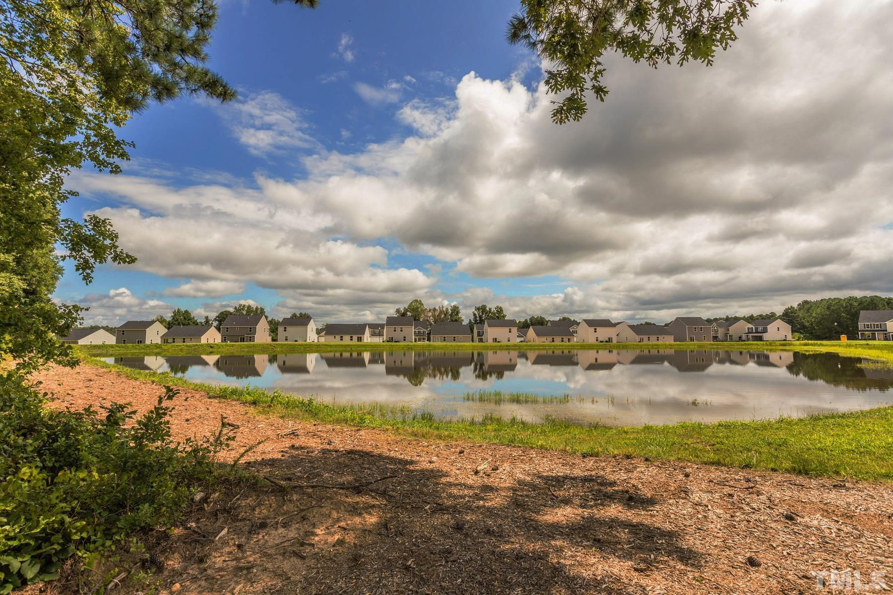 117 Brisk Drive Zebulon, NC 27597 - Photo 9 of 9 a view of a lake with houses in the background
