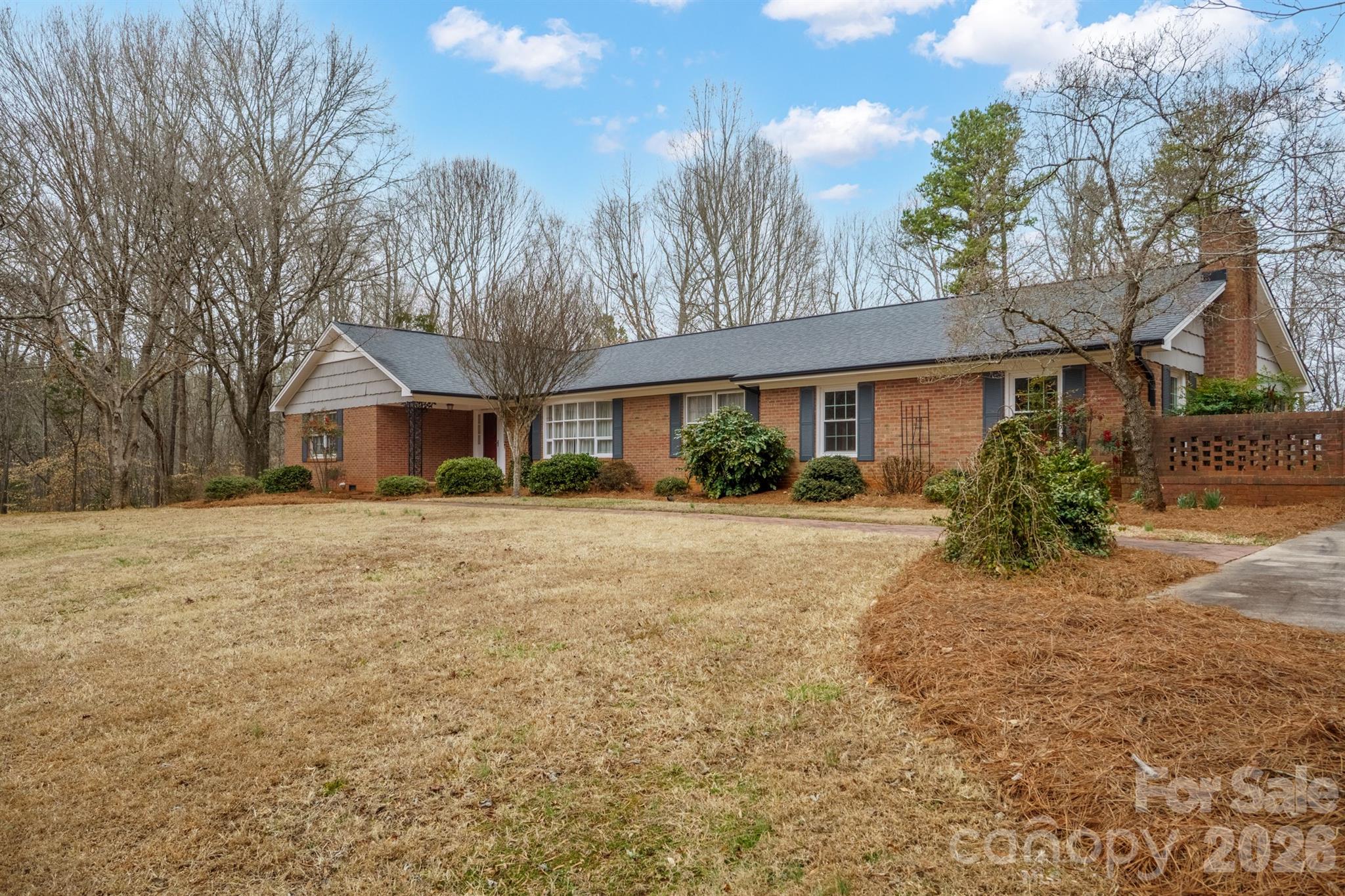 333 Sandy Ford Road Mount Holly, NC 28120 - Photo 1 of 42 a front view of a house with a yard and potted plants