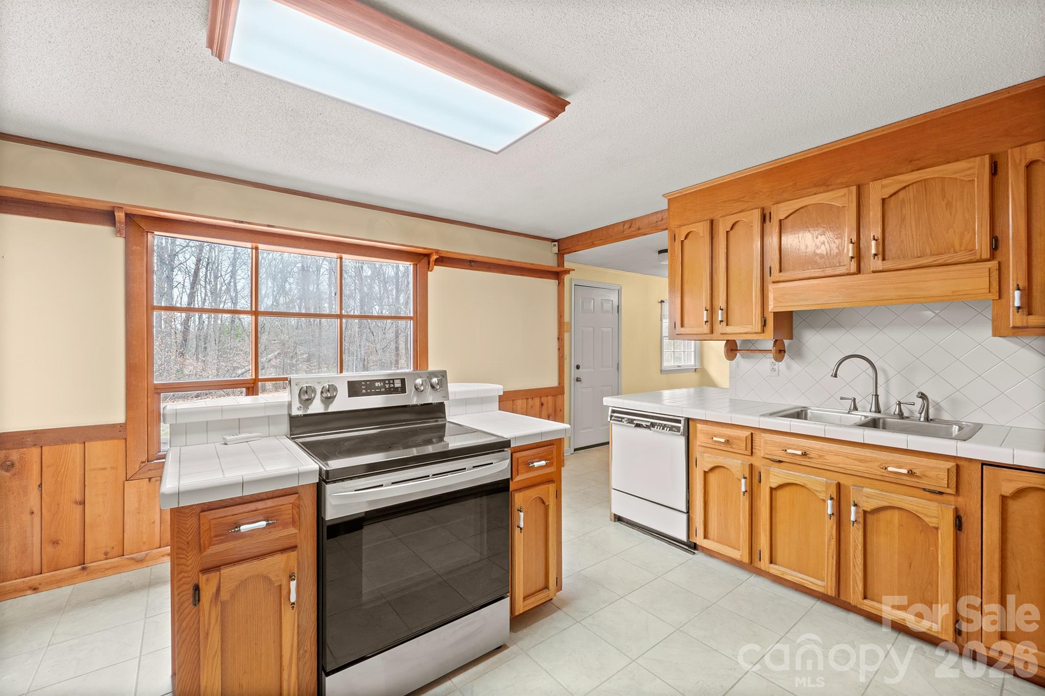 333 Sandy Ford Road Mount Holly, NC 28120 - Photo 18 of 42 a kitchen with stainless steel appliances granite countertop a stove and a sink