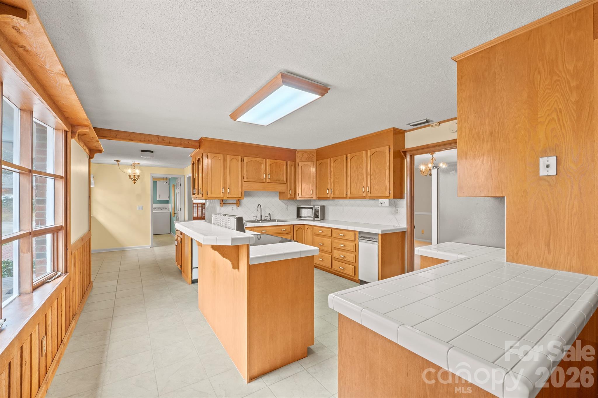 333 Sandy Ford Road Mount Holly, NC 28120 - Photo 22 of 42 a large kitchen with stainless steel appliances a stove a refrigerator a oven and a dining table with wooden floor