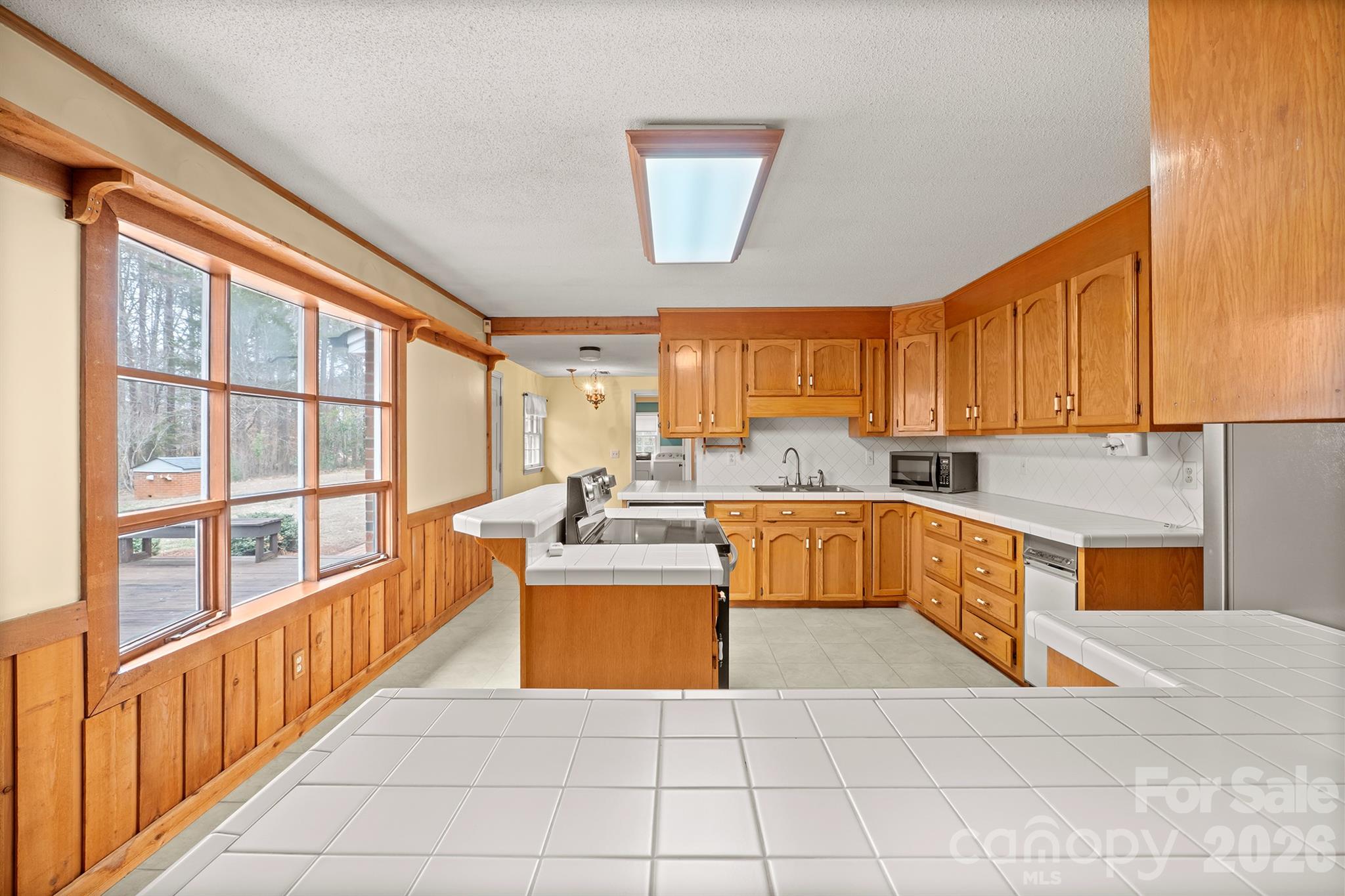 333 Sandy Ford Road Mount Holly, NC 28120 - Photo 23 of 42 a large kitchen with stainless steel appliances granite countertop a large window and a counter space