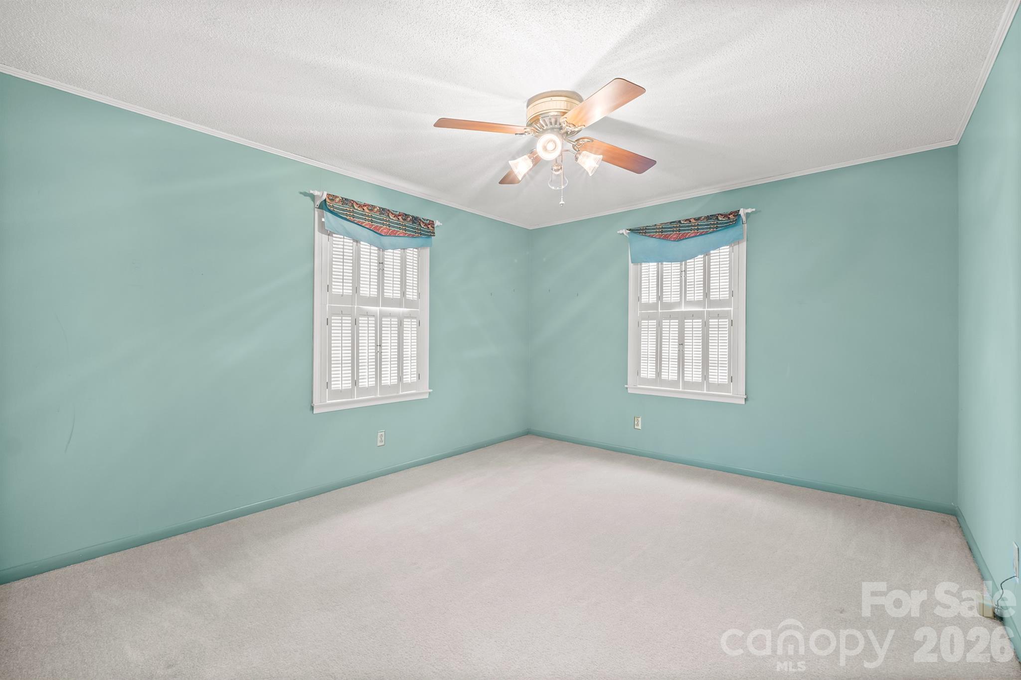 333 Sandy Ford Road Mount Holly, NC 28120 - Photo 30 of 42 an empty room with windows and chandelier fan