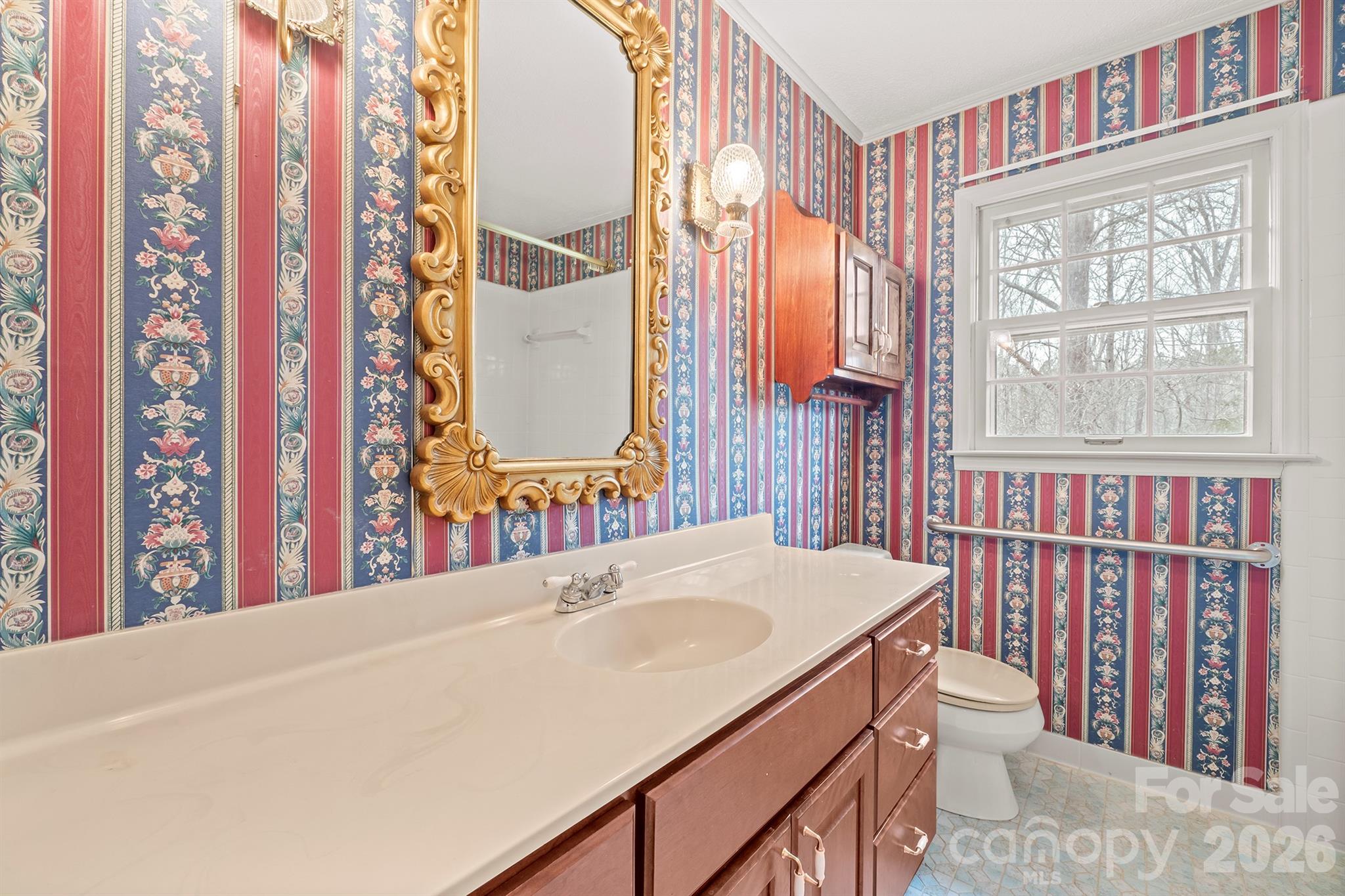 333 Sandy Ford Road Mount Holly, NC 28120 - Photo 35 of 42 a bathroom with a sink and a large mirror next to a window